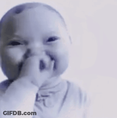 A Baby Is Making A Funny Face With His Finger In His Mouth GIF