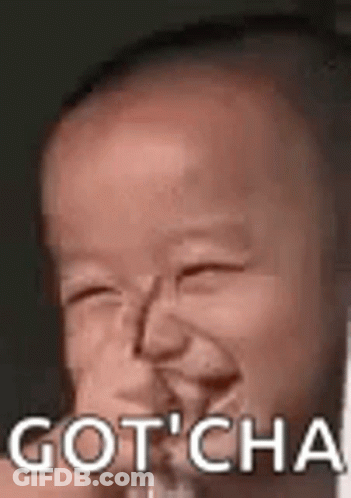 A Baby Is Making A Funny Face With The Words `` Gotcha '' Written Above It . GIF