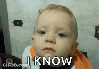 A Baby Is Making A Funny Face With The Words `` I Know '' Written On It . GIF