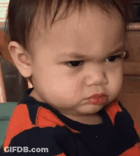 A Baby Is Making An Angry Face And Has Red Lips GIF