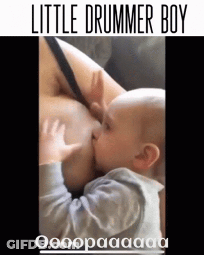 A Baby Is Nursing From A Woman 'S Breast With The Caption Little Drummer Boy GIF