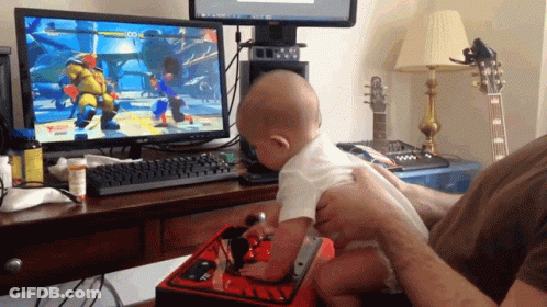 A Baby Is Playing A Video Game On A Dell Computer GIF