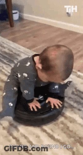 A Baby Is Playing With A Vacuum Cleaner On A Carpet . GIF