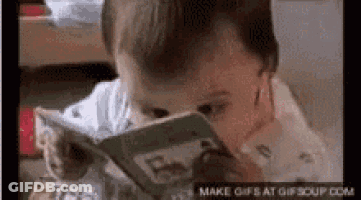 A Baby Is Reading A Book With His Eyes Closed GIF
