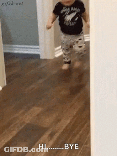 A Baby Is Running On A Wooden Floor And Saying Hi Bye . GIF