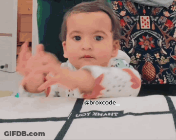 A Baby Is Sitting At A Table With A Blanket That Says Broxcode_ On It GIF