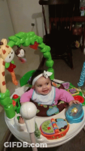 A Baby Is Sitting In A Bouncer With A Giraffe And Monkey On It GIF