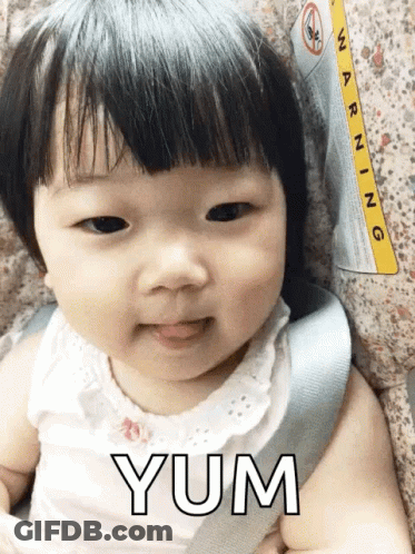 A Baby Is Sitting In A Car Seat With A Warning Label On It GIF