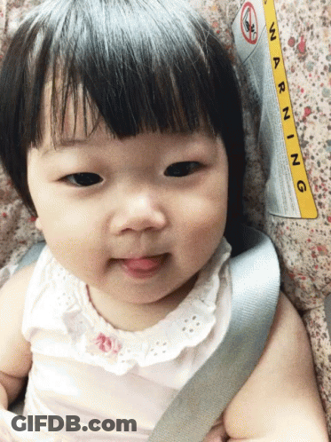 A Baby Is Sitting In A Car Seat With A Warning Label On The Side GIF