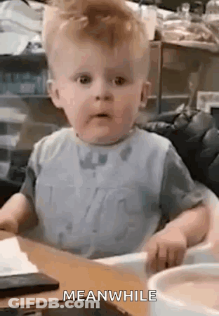 A Baby Is Sitting In A High Chair At A Table With A Bowl Of Food . GIF