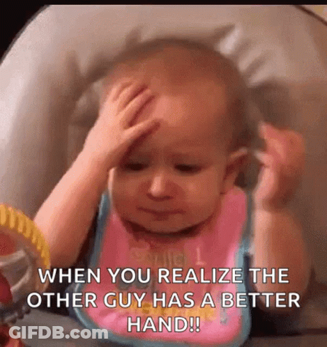 A Baby Is Sitting In A High Chair Holding His Head And Looking At Himself In A Mirror . GIF