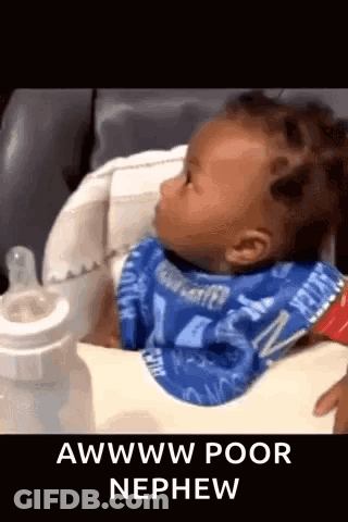 A Baby Is Sitting In A High Chair Next To A Bottle And A Bib . GIF