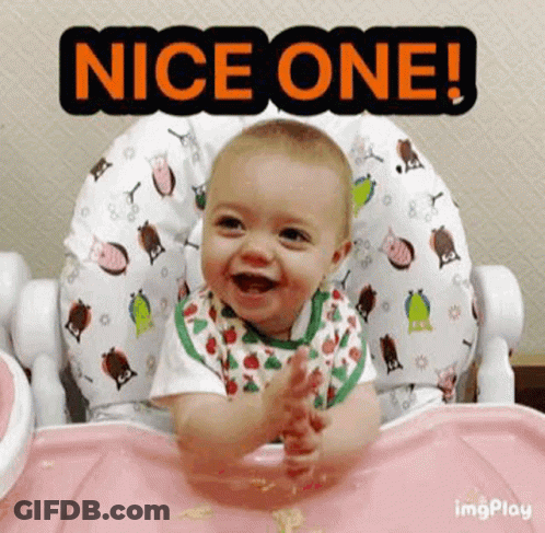 A Baby Is Sitting In A High Chair Smiling And Clapping . GIF
