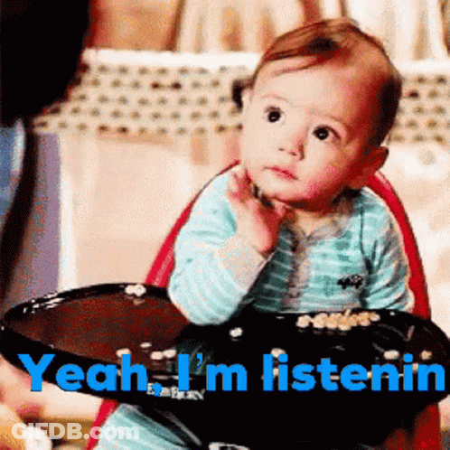 A Baby Is Sitting In A High Chair With The Words " Yeah I 'M Listenin " On The Bottom GIF