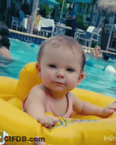 A Baby Is Sitting In A Yellow Float In A Pool GIF