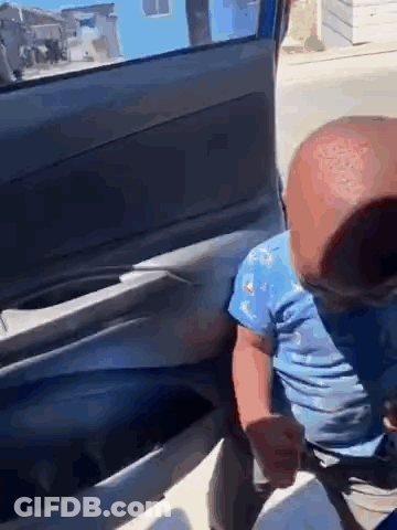 Baby Sitting In Car Back Seat Wearing Mask GIF