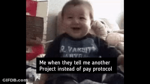 A Baby Is Sitting On A Bed With A Teddy Bear . GIF