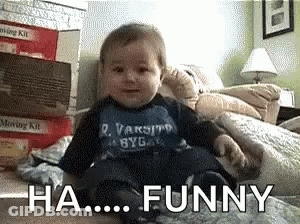 A Baby Is Sitting On A Bed With The Words " Ha Funny " Behind Him GIF