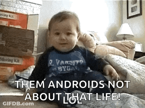 A Baby Is Sitting On A Bed With The Words " Them Androids Not About That Life " On The Bottom GIF