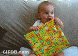 A Baby Is Sitting On A Couch Holding A Happy Birthday Gift GIF