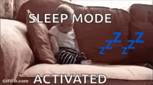 A Baby Is Sitting On A Couch With The Words `` Sleep Mode Activated '' Above It . GIF