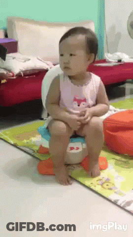 A Baby Is Sitting On A Potty In A Living Room With Imgplay Written On The Bottom Right GIF