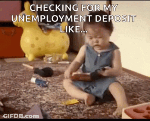 A Baby Is Sitting On The Floor Playing With A Toy And A Phone . GIF