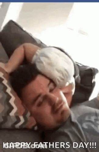 A Baby Is Sleeping On A Man 'S Head . GIF