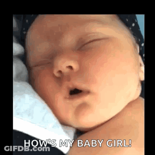 A Baby Is Sleeping With Its Mouth Open And A Person Is Holding It . GIF