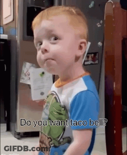 A Baby Is Standing In Front Of A Refrigerator With The Words Do You Want Taco Bell Written On It . GIF
