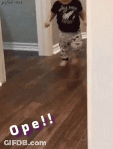 A Baby Is Walking On A Wooden Floor And The Word Ope Is On The Floor GIF