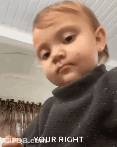 A Baby Is Wearing A Black Sweater And Making A Funny Face And Saying `` Your Right '' . GIF