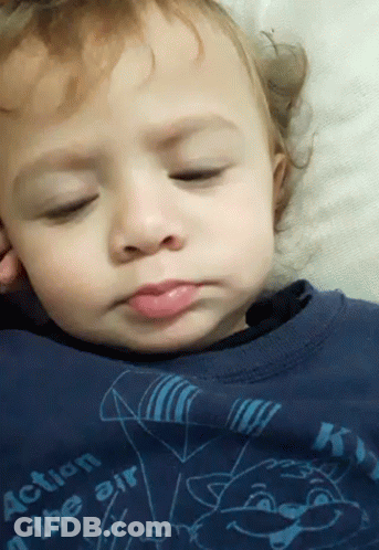 A Baby Is Wearing A Blue Shirt That Says Action In The Air GIF