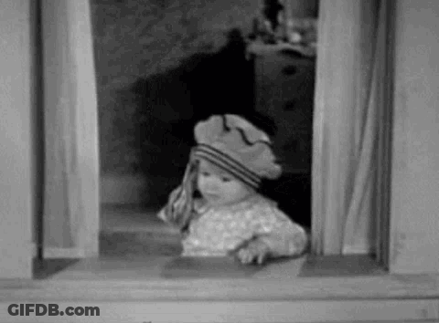 A Baby Is Wearing A Hat And Looking Out Of A Window . GIF