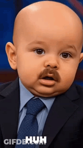A Baby Is Wearing A Suit And Tie And Has A Mustache GIF