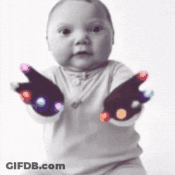 Baby Wearing White Shirt And Black Dotted Gloves GIF