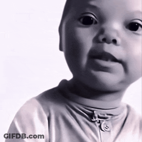 A Baby Is Wearing A White Shirt With A Zipper On The Front GIF