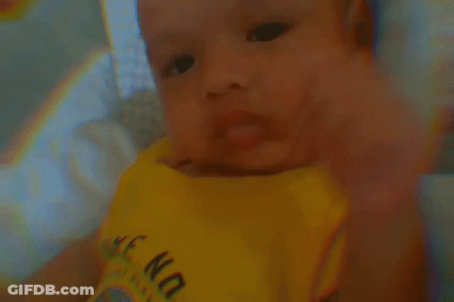 A Baby Is Wearing A Yellow Shirt That Says " Wake No " GIF
