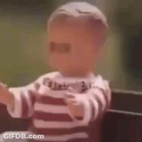 A Baby Is Wearing Sunglasses And A Striped Shirt And Is Sitting On A Bench . GIF