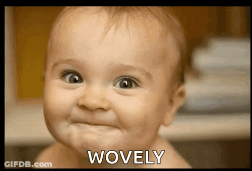 A Baby Making A Face With The Word Wovely Above It GIF