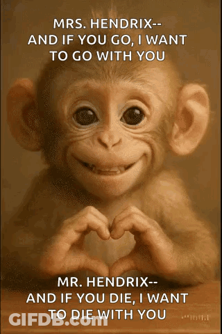 A Baby Monkey Is Making A Heart Shape With Its Hands . GIF