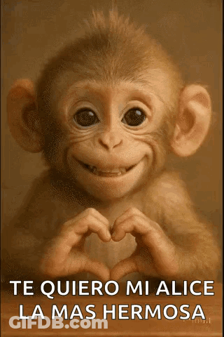 A Baby Monkey Is Smiling And Making A Heart Shape With Its Hands . GIF