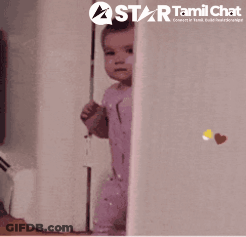 A Baby Peeking Out From Behind A Wall With A Star Tamil Chat Logo Behind It GIF