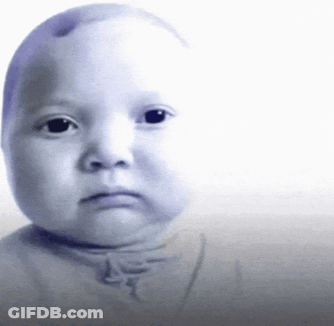 A Baby 'S Face Is Shown With A Serious Look On His Face GIF