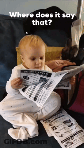 A Baby Sitting On A Couch Reading A Newspaper That Says Buffet GIF