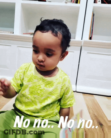A Baby Sitting On The Floor With The Words No No No No GIF