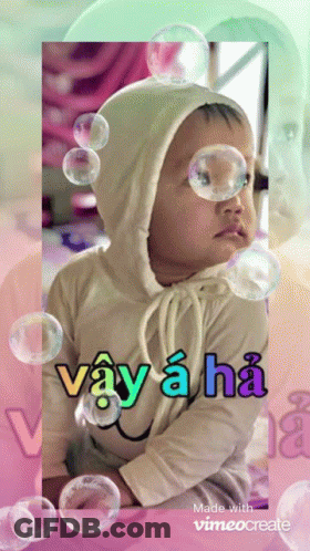 A Baby Surrounded By Soap Bubbles With The Words Vay A Ha GIF