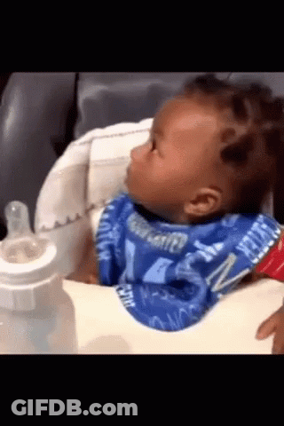 A Baby Wearing A Bib That Says Water On It Is Sitting In A High Chair GIF