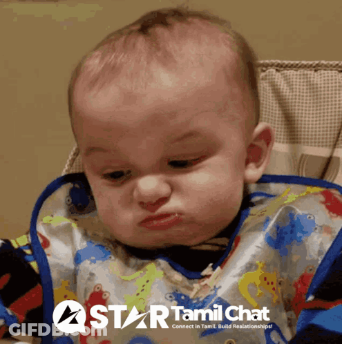 A Baby Wearing A Bib With A Star Tamil Chat Logo On The Bottom GIF