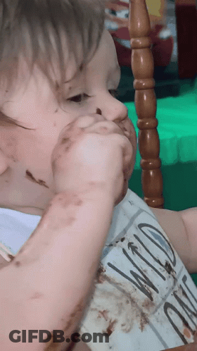 A Baby Wearing A Bib With Wild On It GIF